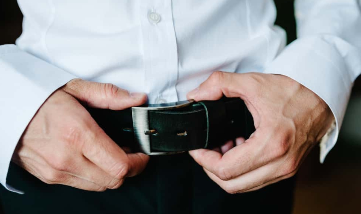 A Man In Pants And Shirt Buttoned A Black Leather Trouser Belt, Shutterstock, 1537966943