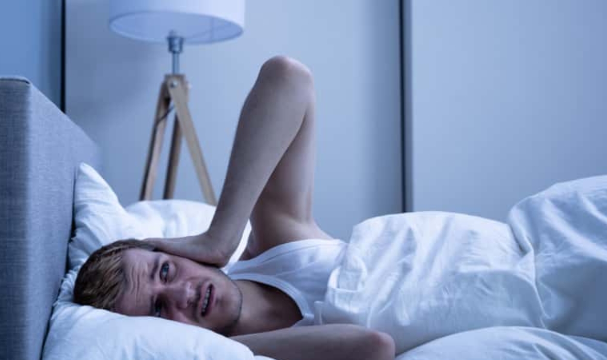 Man Covering His Head With Pillow In Bed, Shutterstock, 1503717920