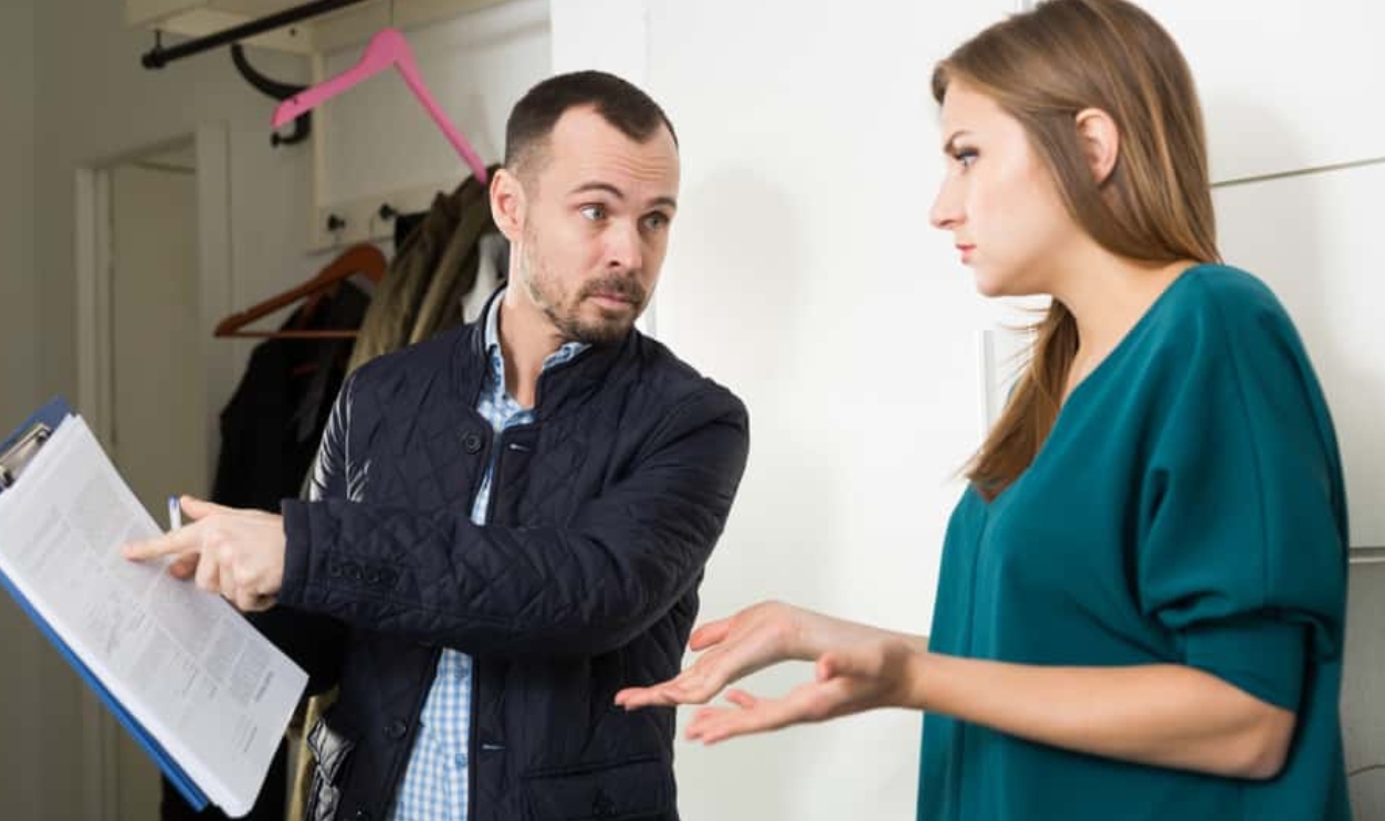 Portrait Of Young Frustrated Woman Talking To Debt Collector, Shutterstock, 1386468416