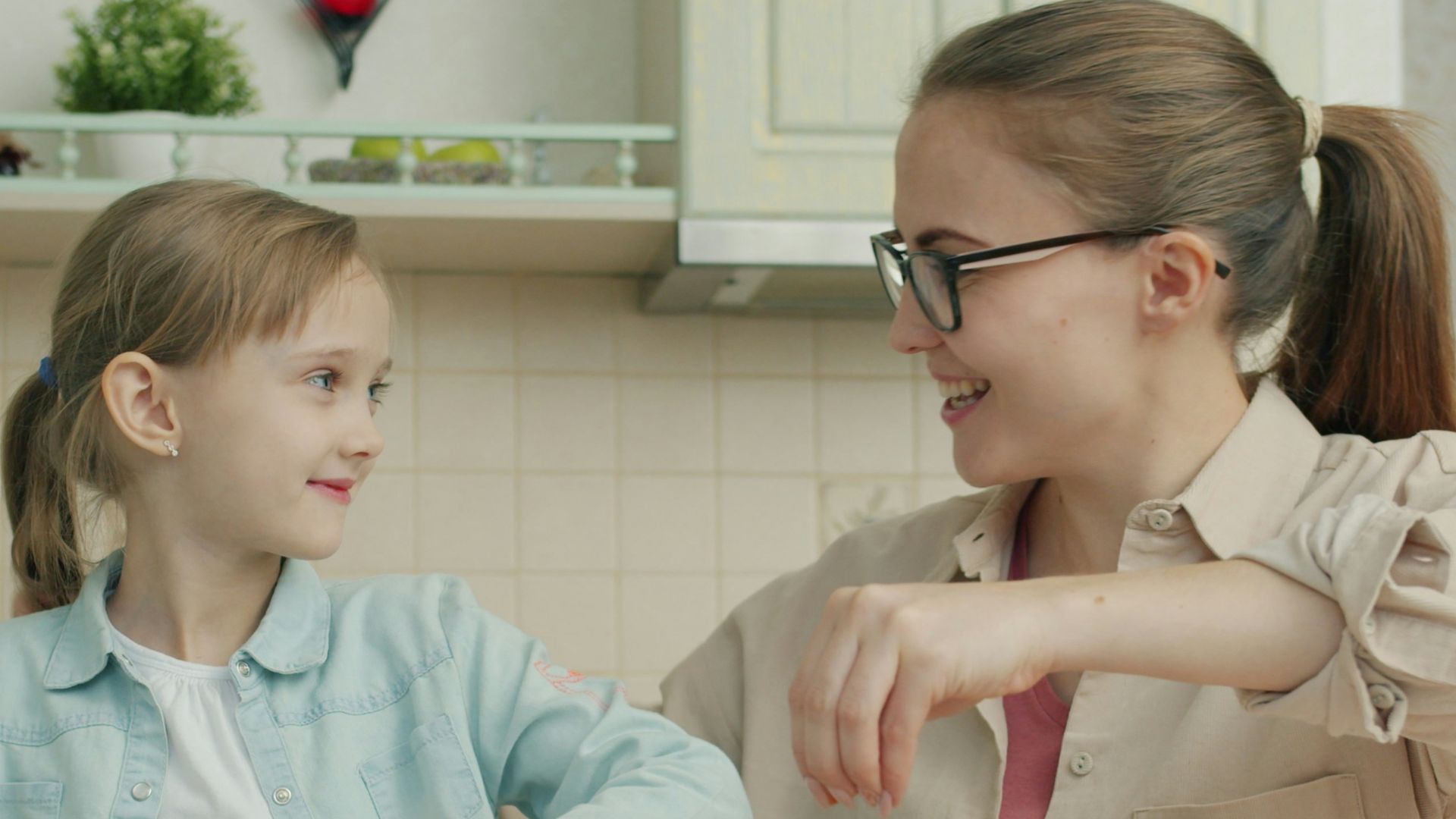 Mother and daughter decorating cookies in the kitchen