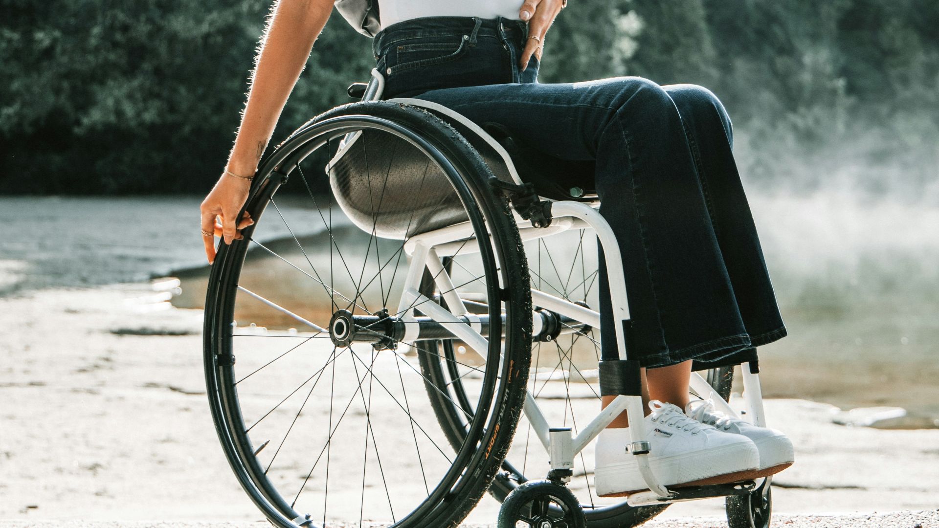 woman riding wheelchair near trees