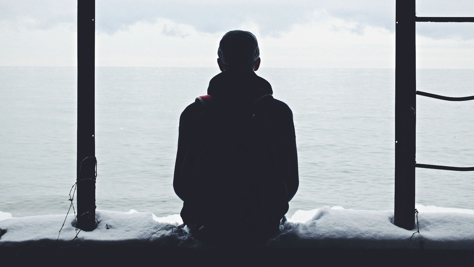 person looking out through window