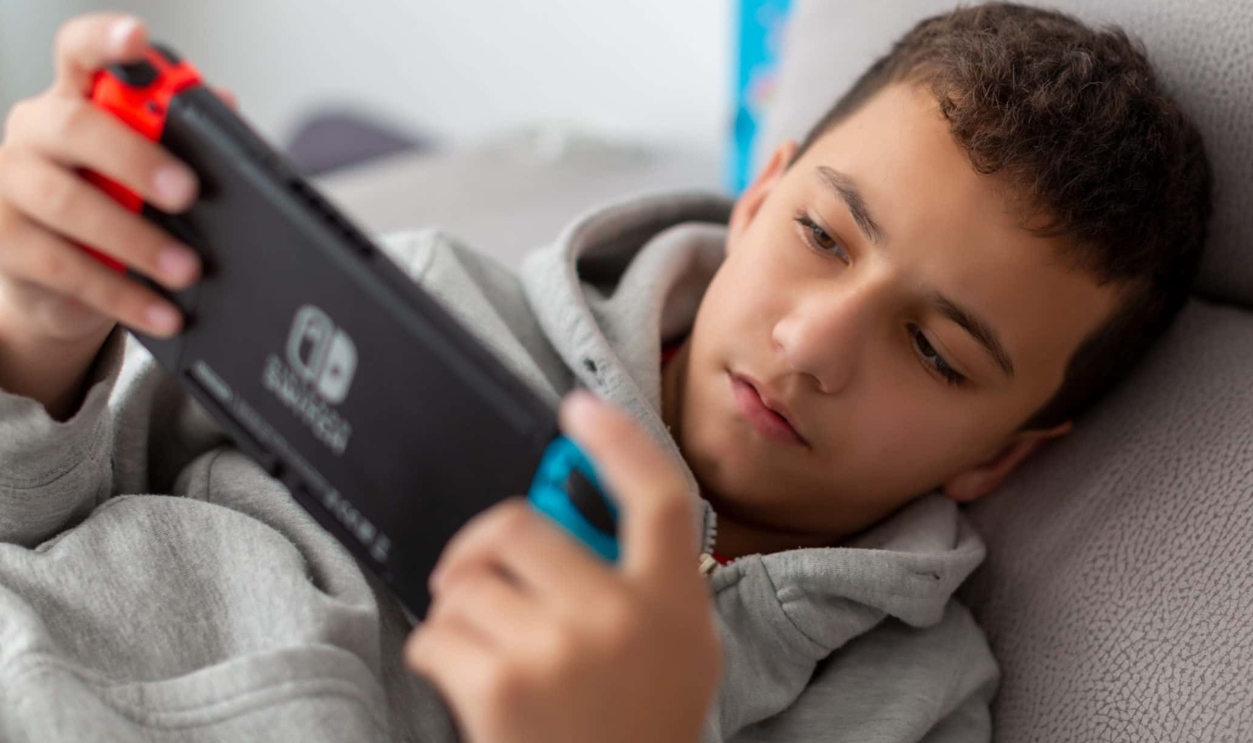 A Man Playing Nintendo Switch, Shutterstock, 1607680231