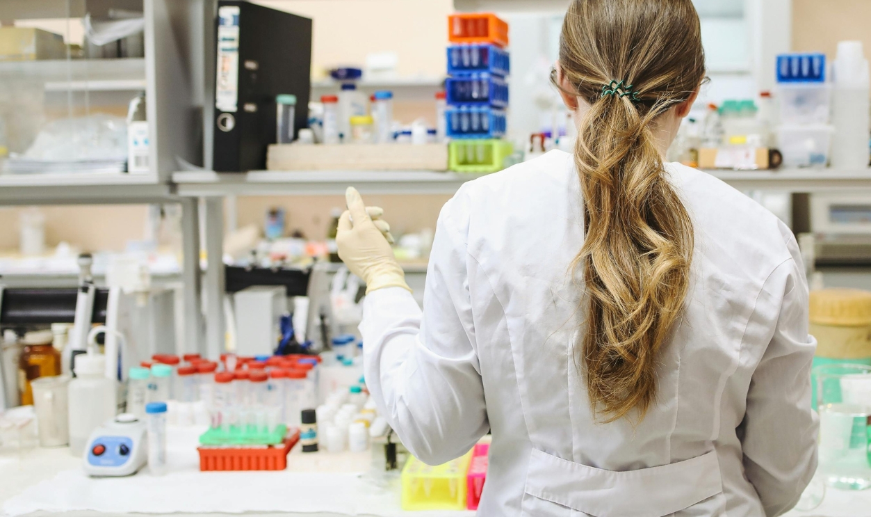 Woman-In-White-Long-Sleeved-Laboratory-Gown-Standing