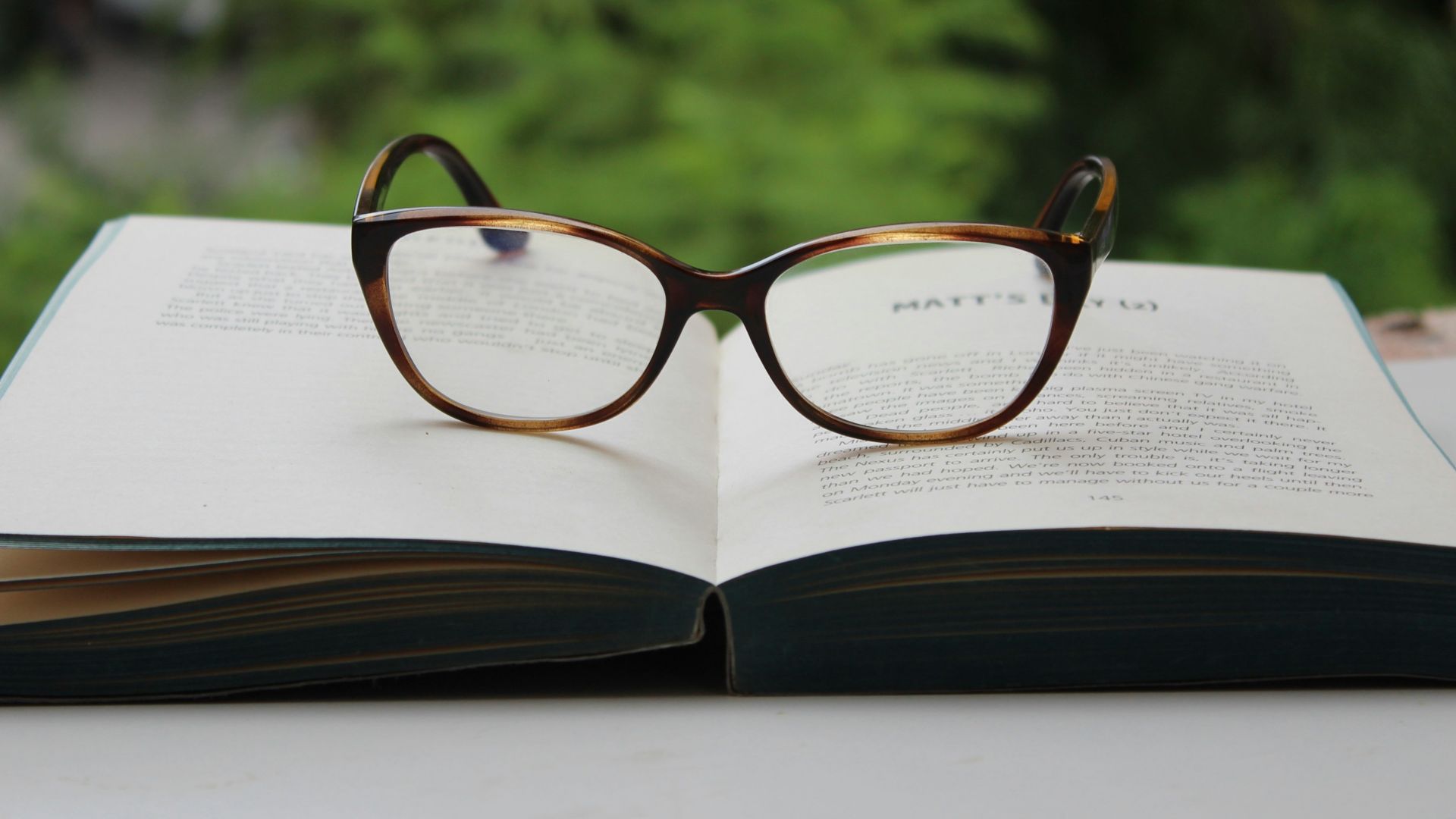 brown framed eyeglasses on book page