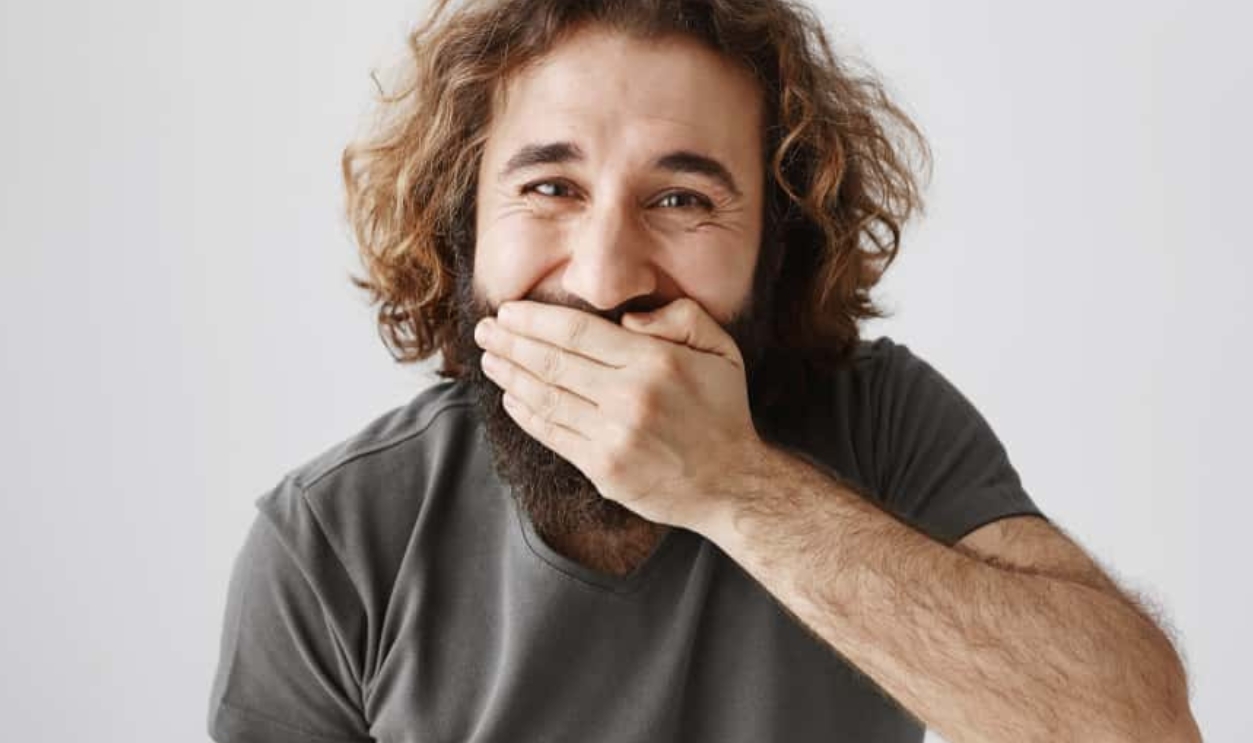 Cheerful Eastern Man Laughing And Covering Mouth, Shutterstock, 1060154249