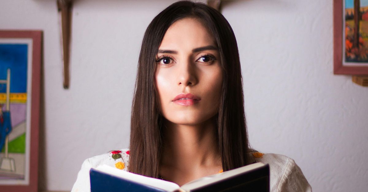 A woman looking worried after reading something.