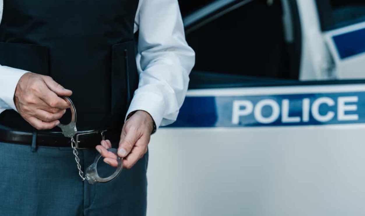 Police Officer Holding Handcuffs, Shutterstock, 1178413129