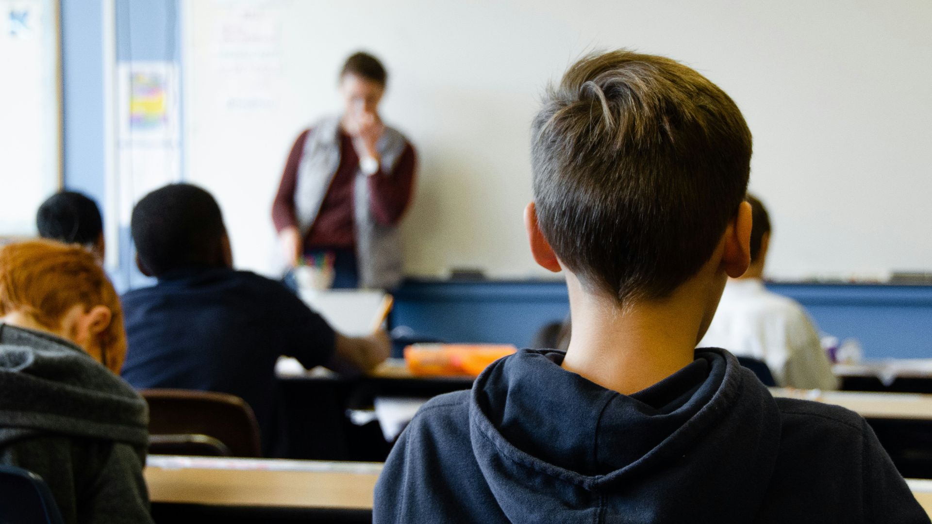 boy in black hoodie sitting on chair