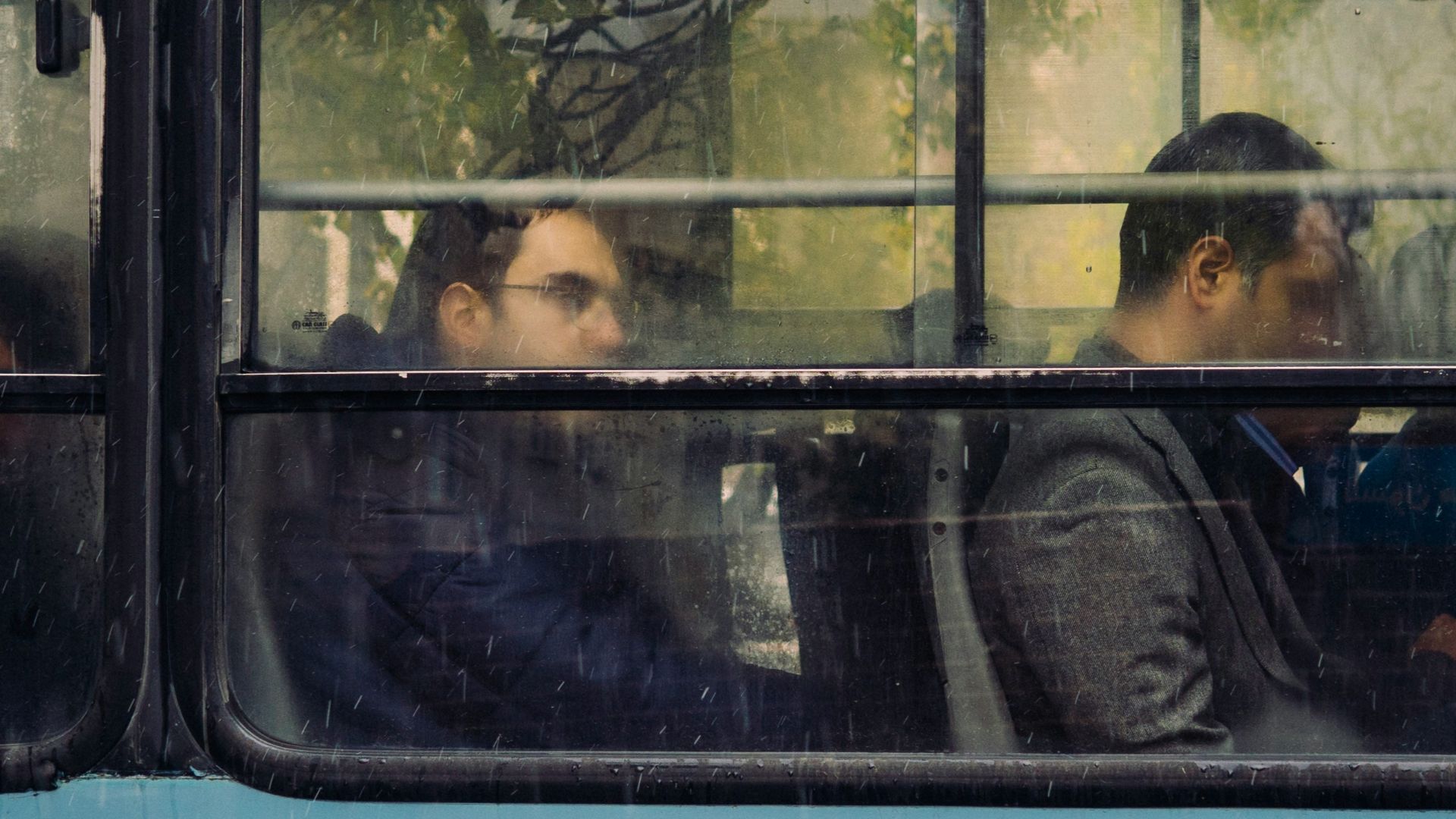 people sitting in blue bus during daytime