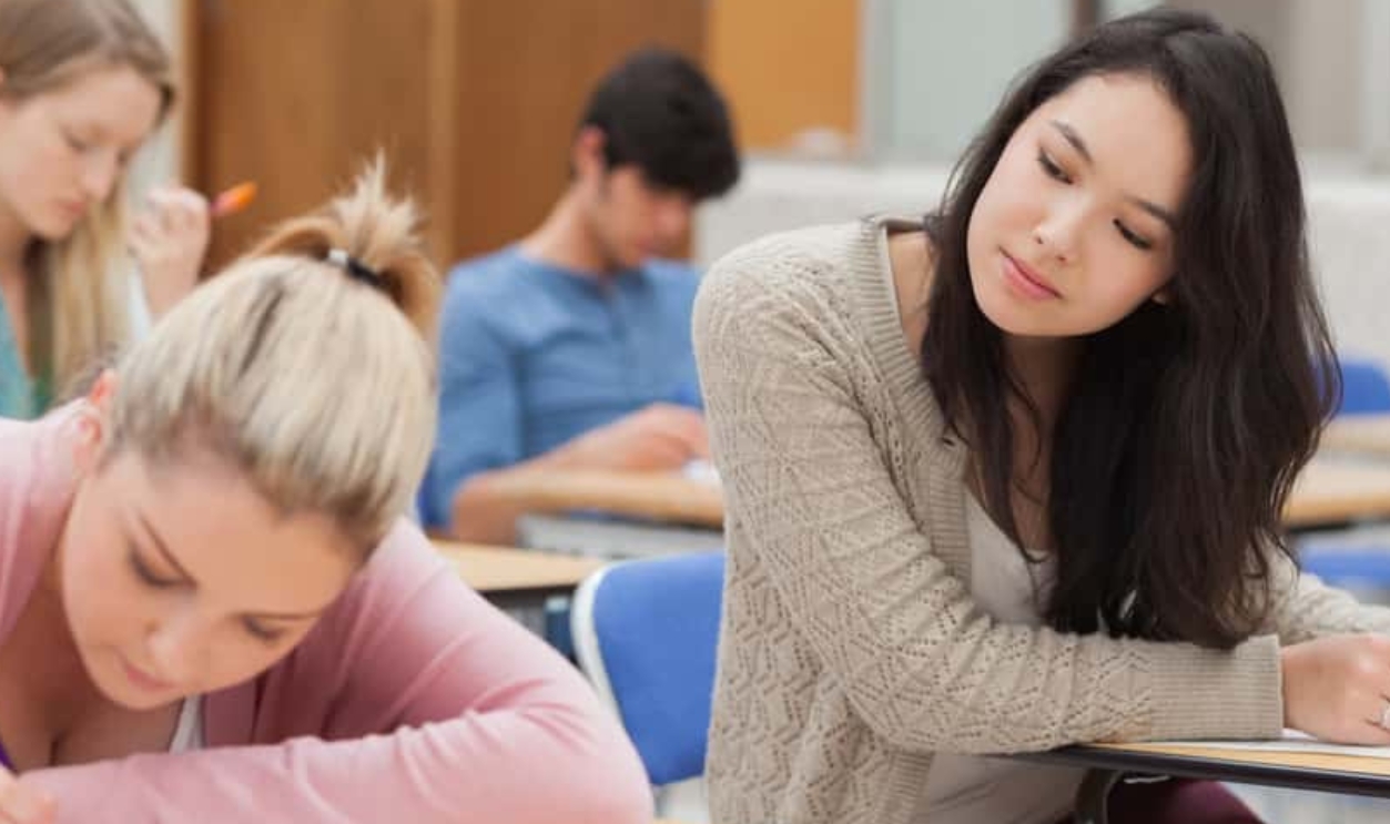 Girl Copying Another Students Work In Exam, Shutterstock, 116468983