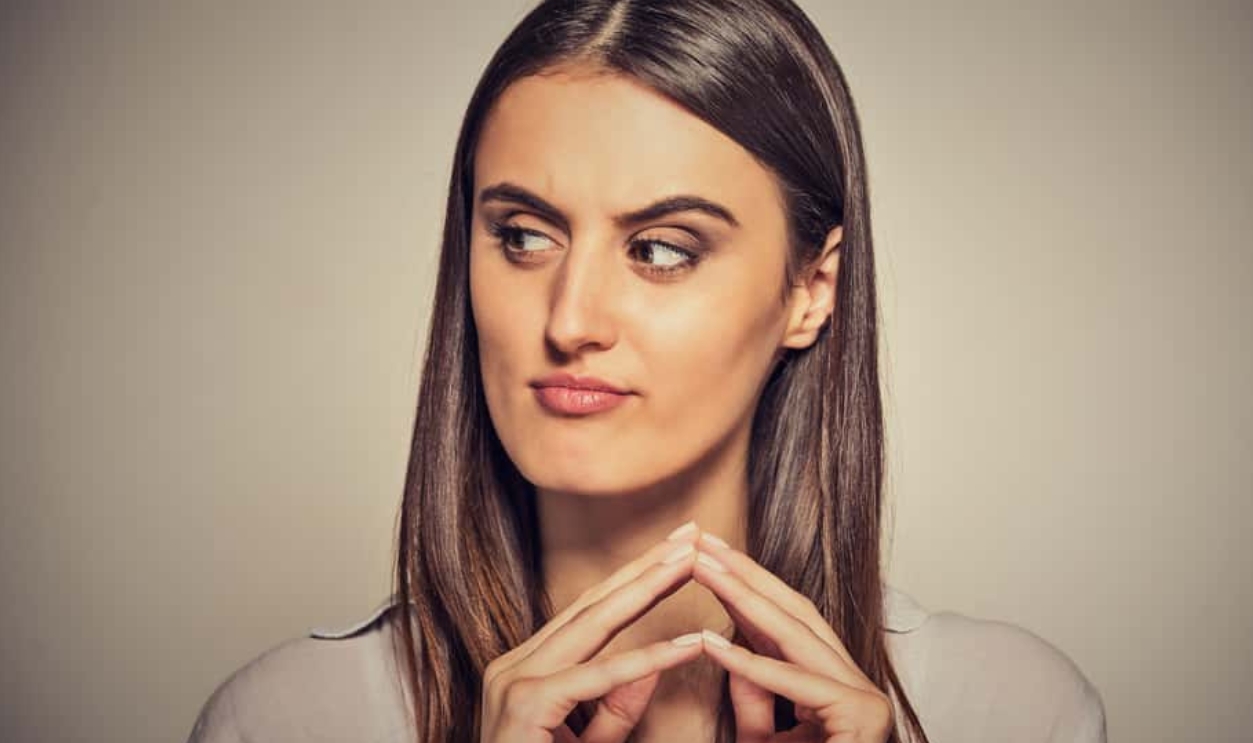 Sneaky, Sly, Scheming Young Woman Plotting, Shutterstock, 363602234