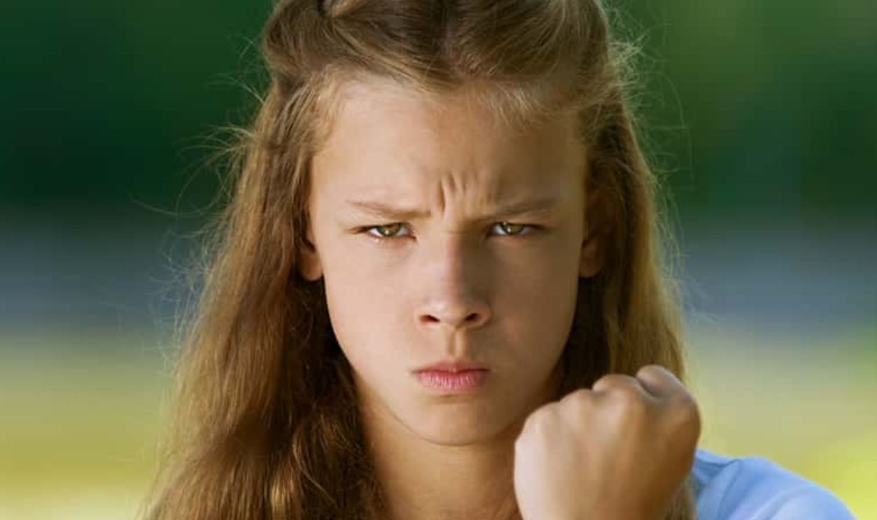 Teenage Girl Shakes Her Fist, Shutterstock, 119481484