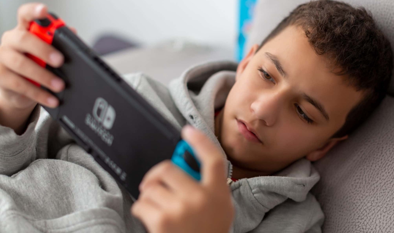 A Man Playing Nintendo Switch, Shutterstock, 1607680231