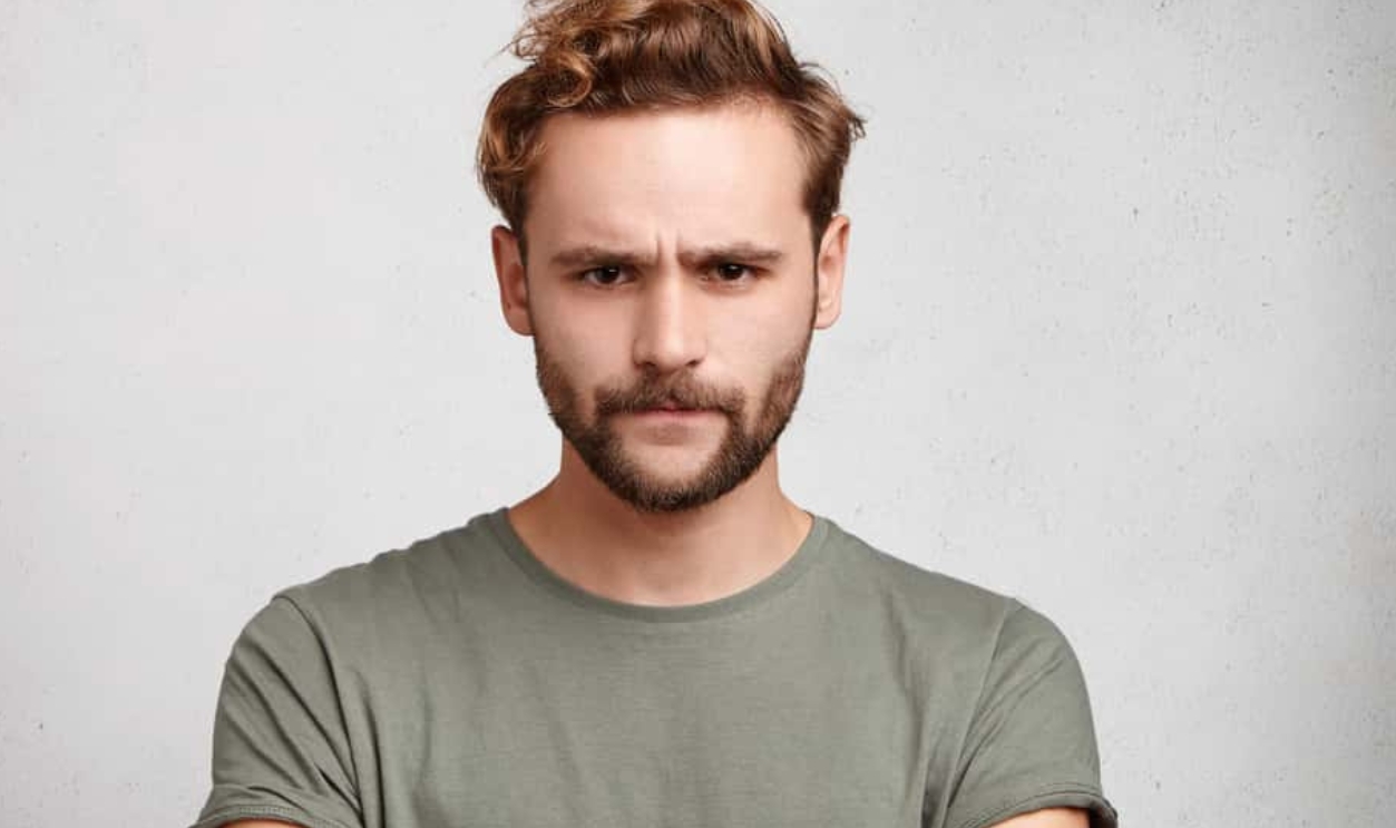 Bearded Guy Frowns Face,, Shutterstock, 744195100
