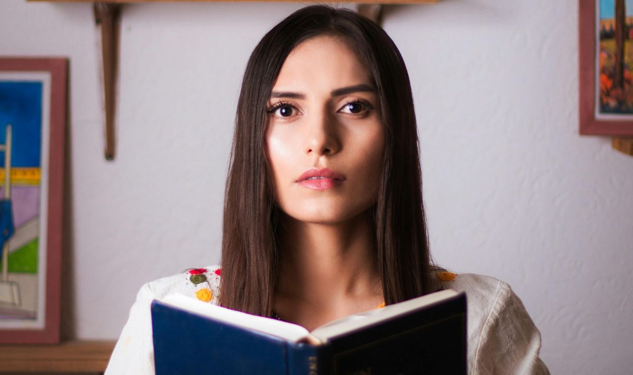 Woman holding blue book