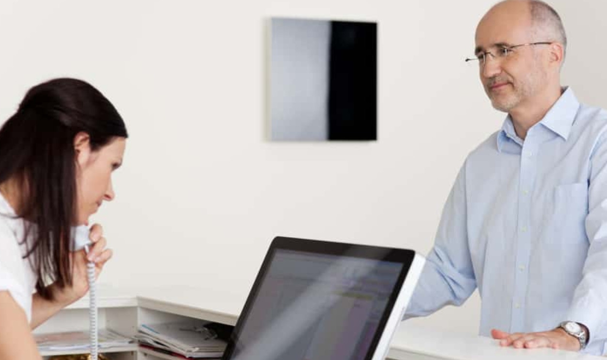 Male Patient Looking At Female Receptionist, Shutterstock, 144113662 (2)