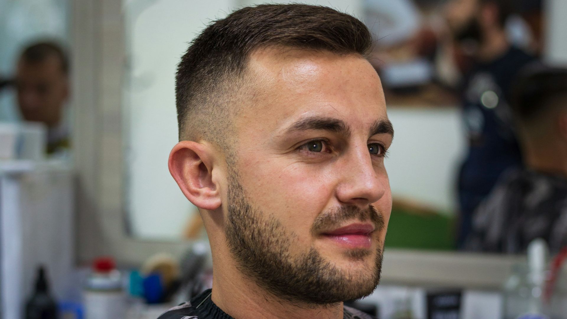 a man in a barber shop getting his hair cut
