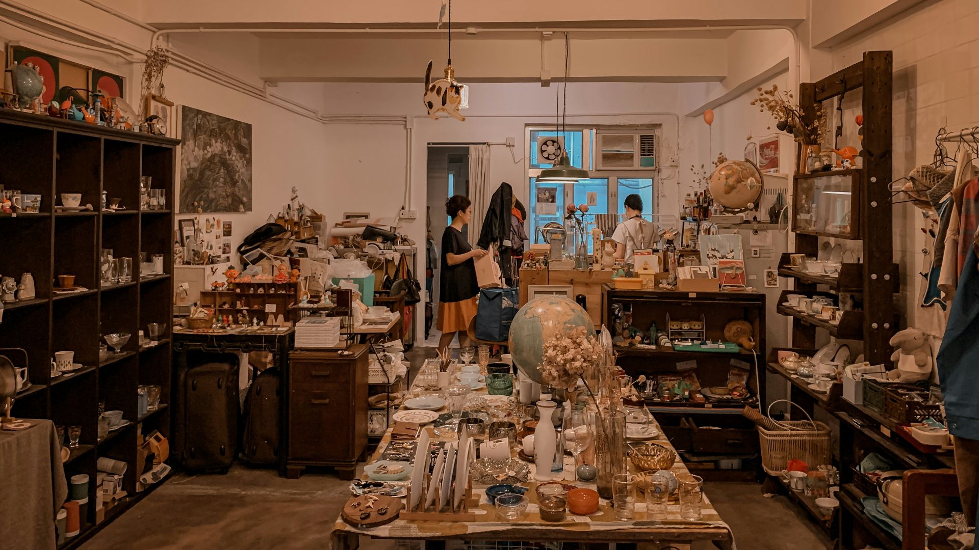 woman in black jacket standing in front of kitchen counter