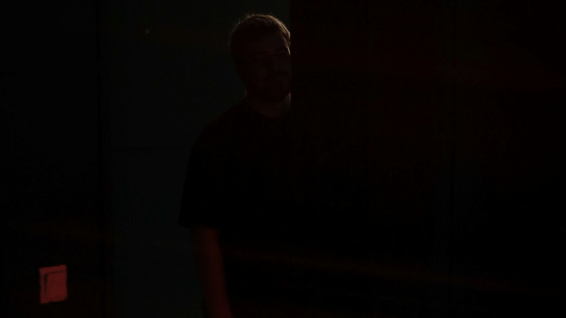 a man standing in a dark room