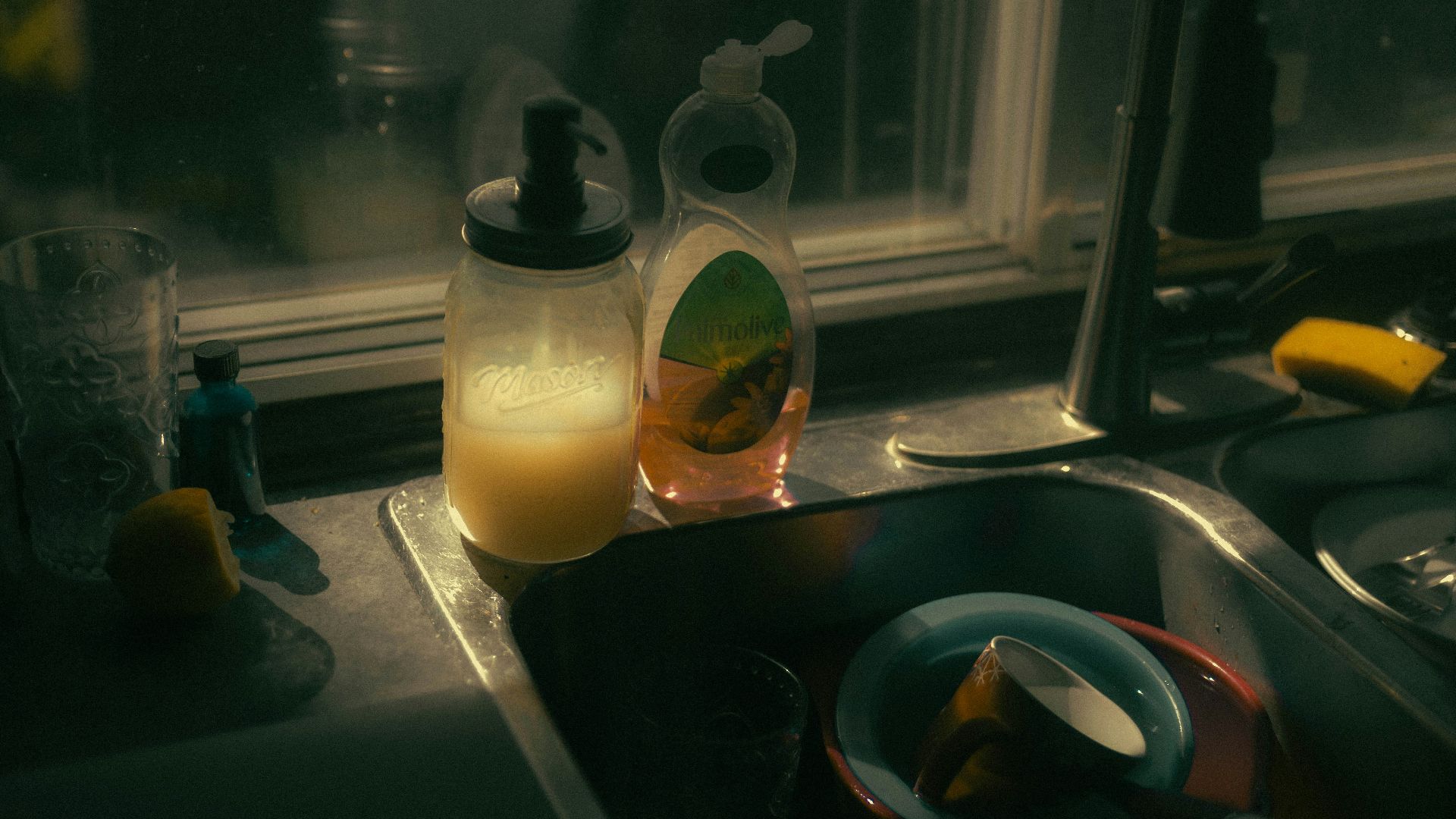 a kitchen sink filled with dishes next to a window