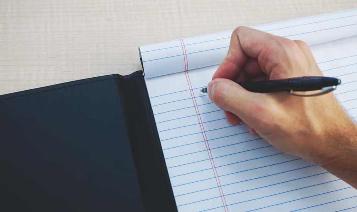 Writing on Paper Notebook