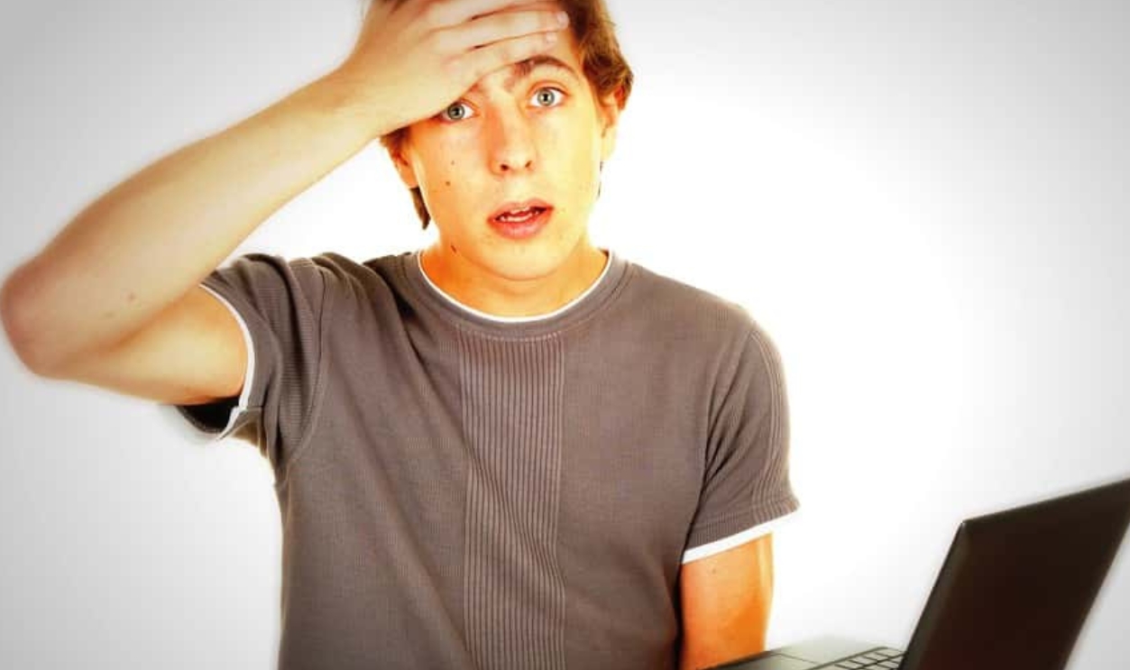 Scared Young Man Working On Laptop, Shutterstock, 85591591