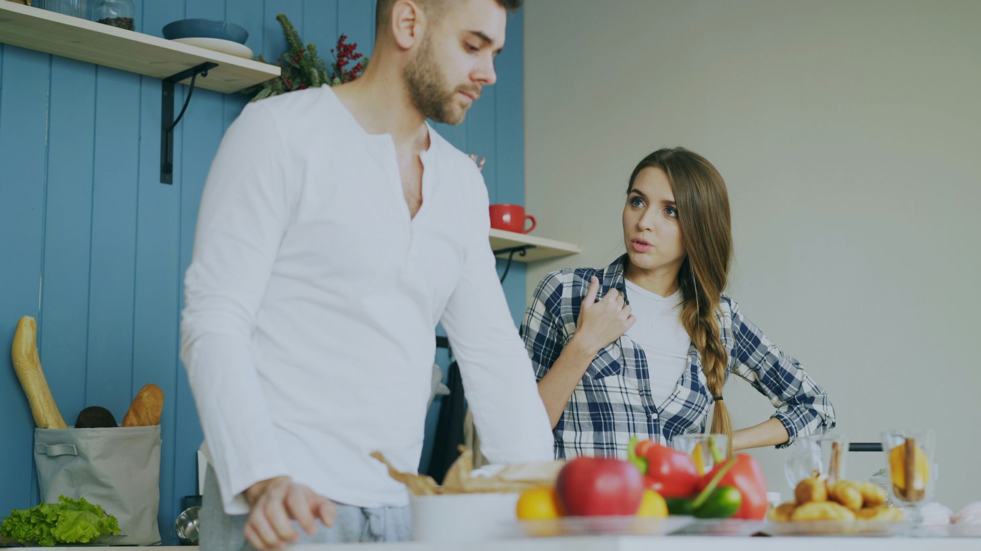 Couple arguing in a kitchen