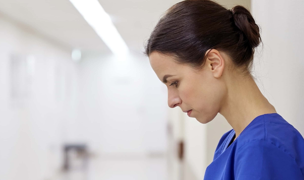 Sad Female Nurse At Hospital Corridor, Shutterstock, 360888332