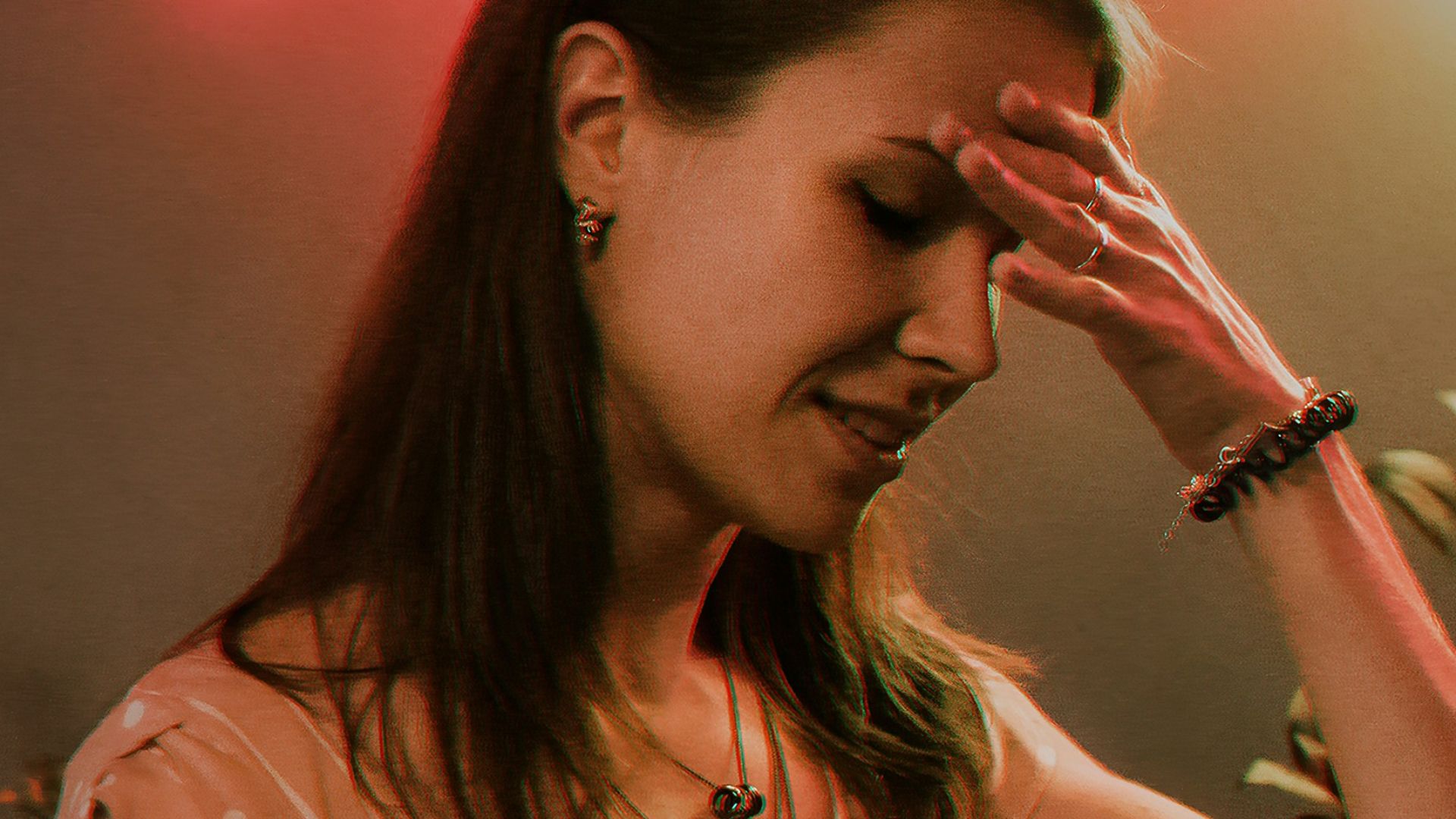 a woman standing in front of a neon sign