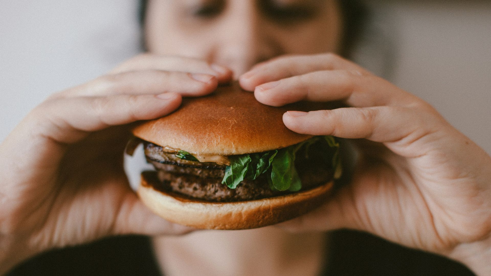 person holding burger