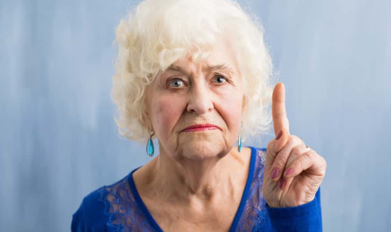 Grandma Holding Her Finger Up, Shutterstock, 586963580