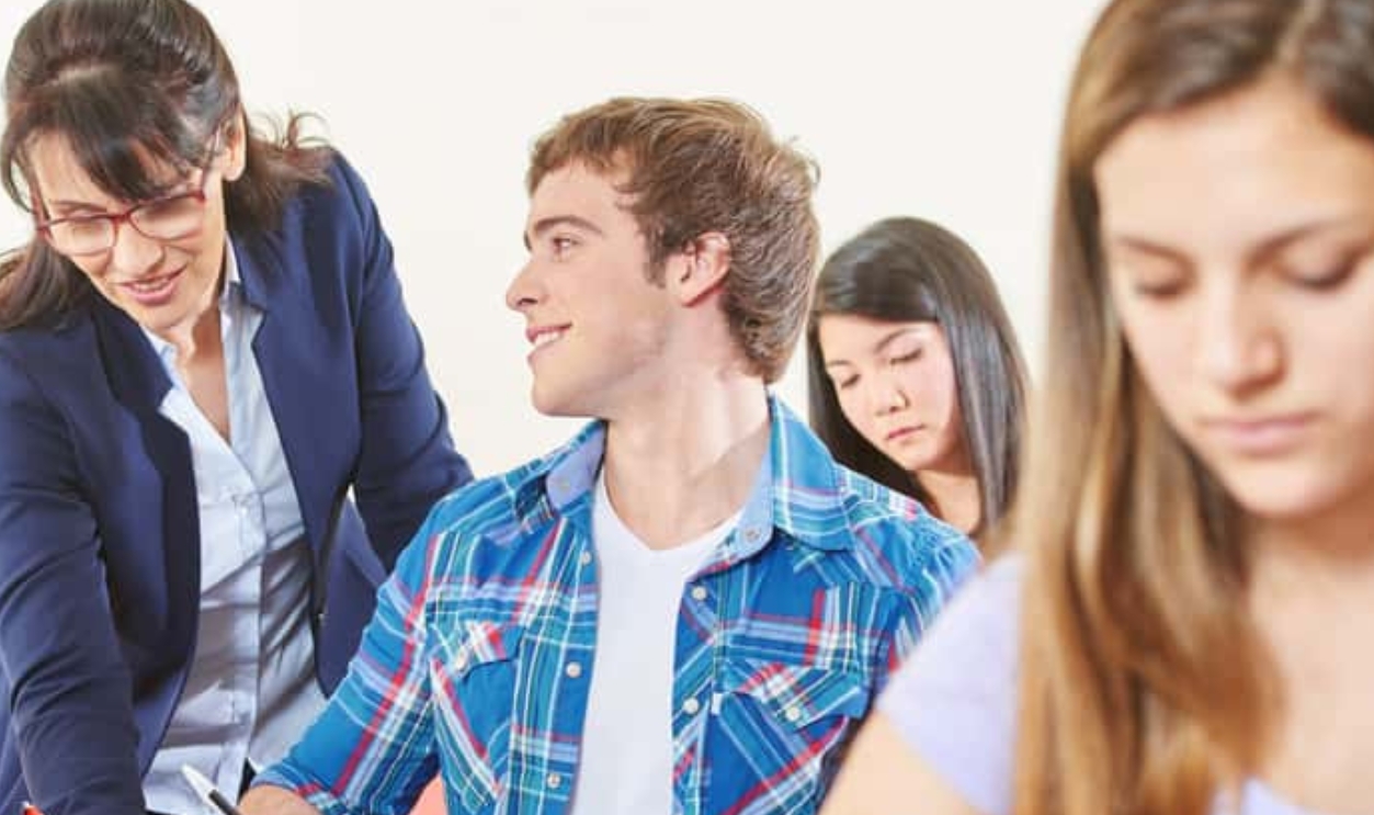 Teacher Helps A Student In A Test, Shutterstock, 475094389