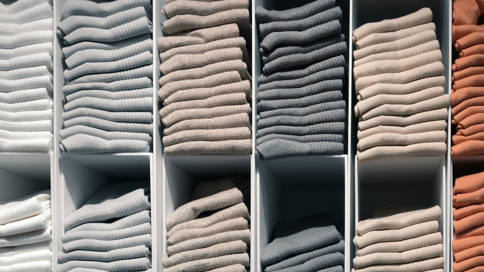 white and yellow textiles on brown wooden shelf
