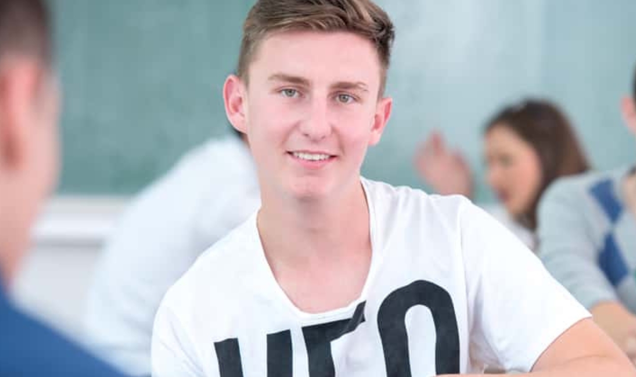 Smiling Highschool Boy Posing In Classroom, Shutterstock, 168934946