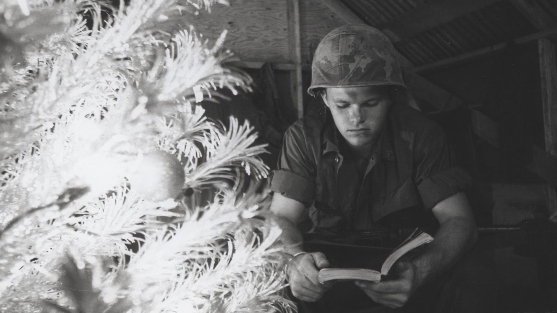 File:Marine Reads in Front of a Christmas Tree, Quang Tri, Vietnam, 1968 (11516191463).jpg