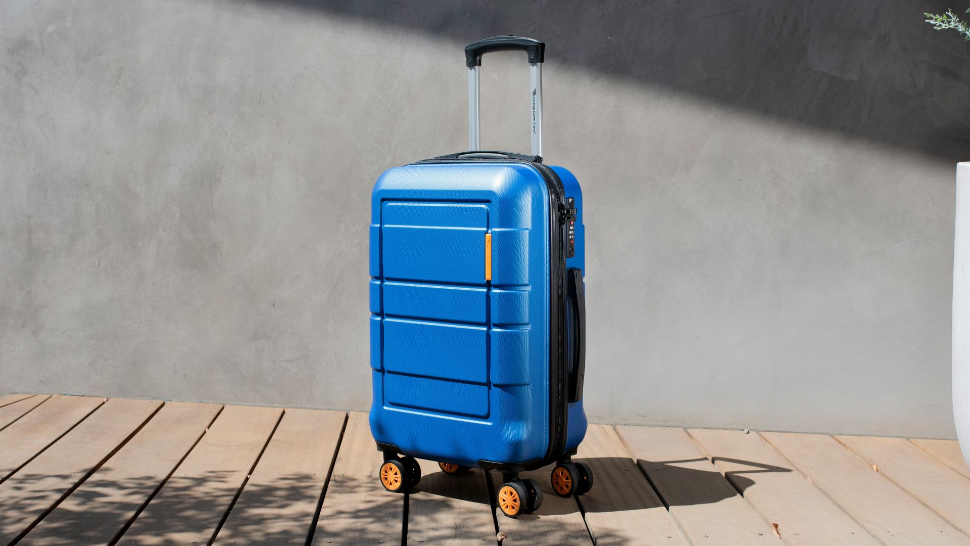 a blue suitcase sitting on top of a wooden floor