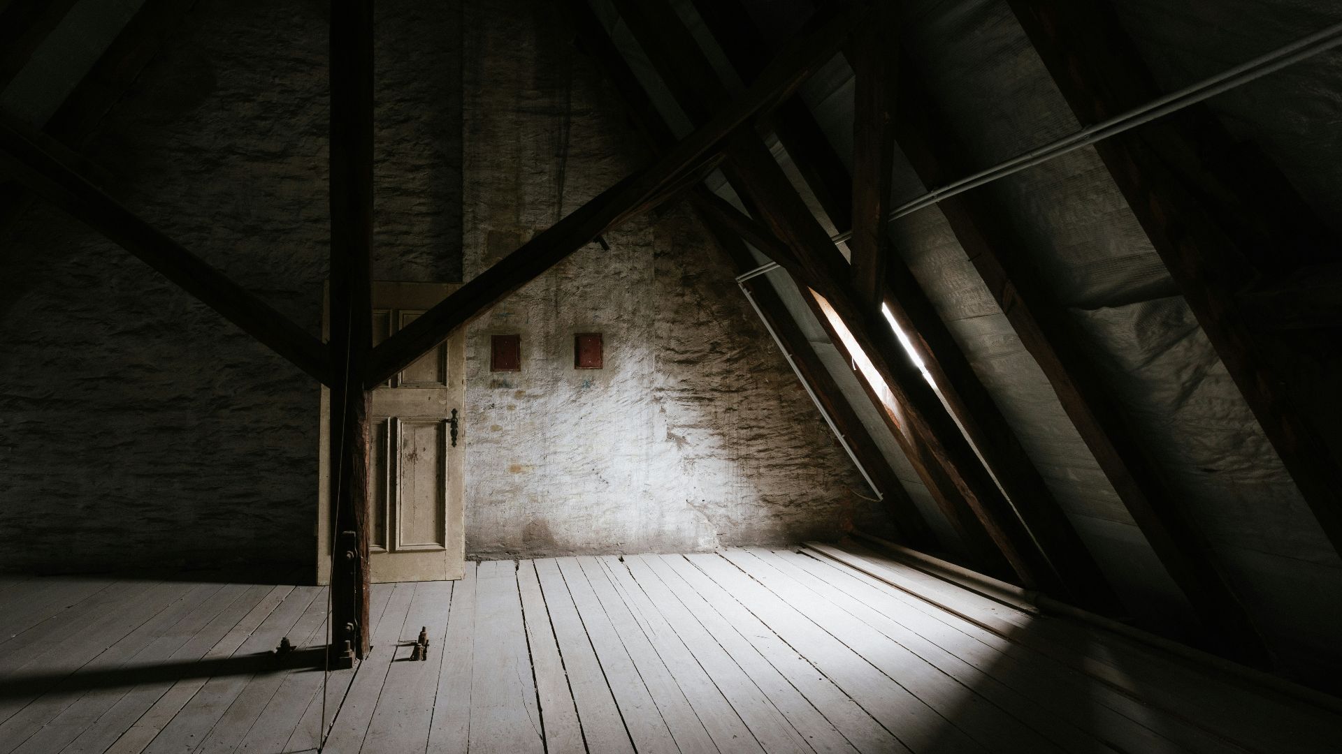 a wooden walkway with a light at the end