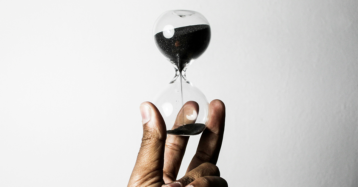 person holding an hourglass