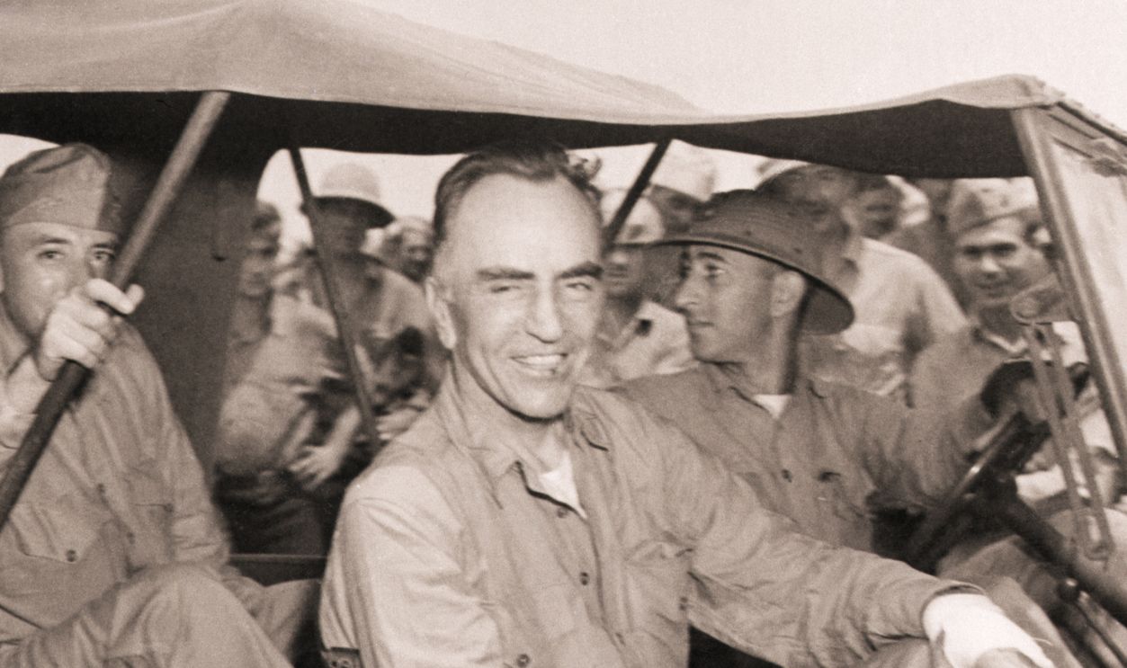 Gettyimages - 515571062, Eddie Rickenbacker After His Raft Rescue (Original Caption) 11/24/1942- At a South Pacific base a few hours after his recent rescue from a life raft on which her floated for three weeks, Capt. Eddie Rickenbacker(right) flashes his famous smile on his way to a meal of soup and ice cream. Col. Robert L. Griffin, Jr.