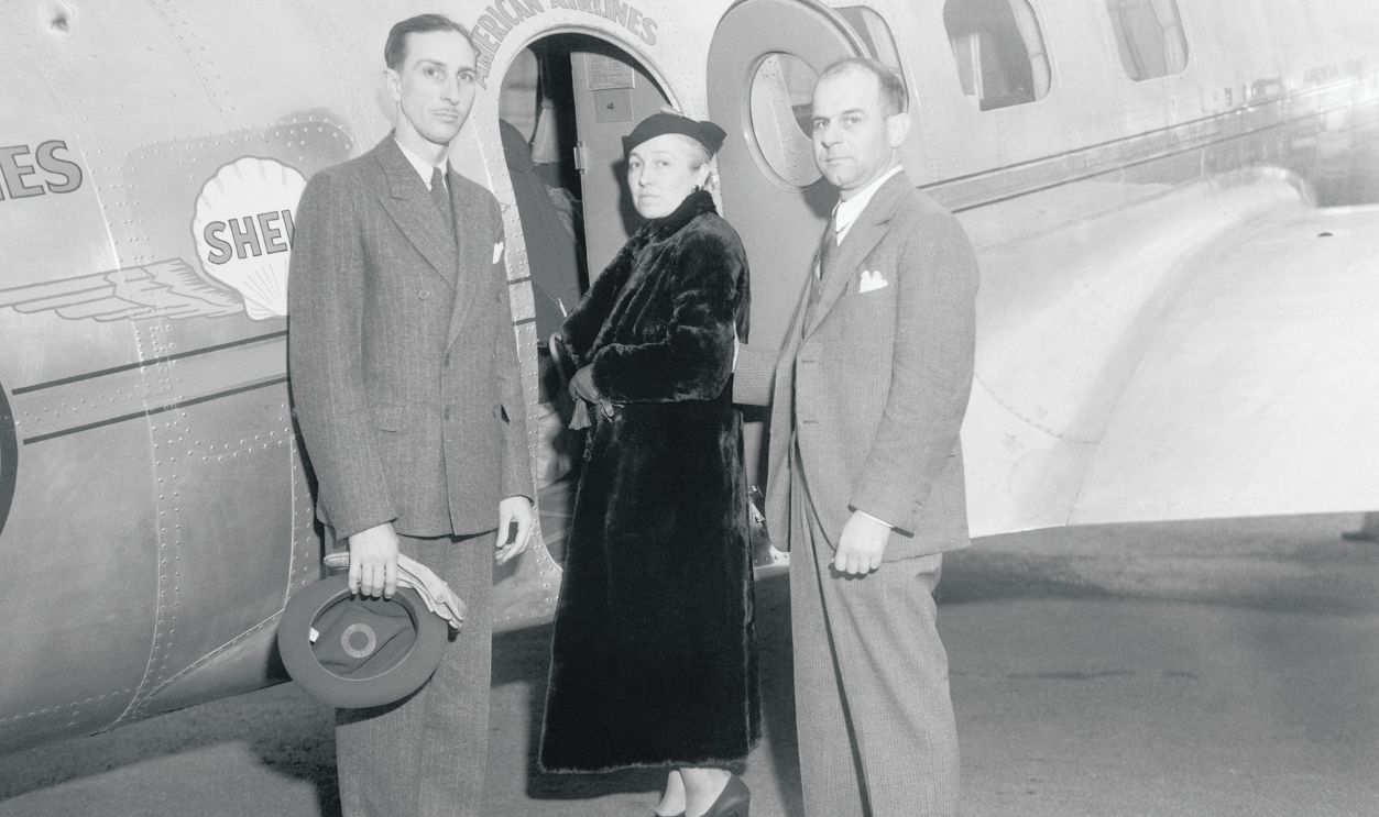 Gettyimages - 515607952, Racer Jimmy Doolittle With Wife and Robert Adamson by Airplane (Original Caption) Major Jimmy Doolittle, speed pilot, hung up a new transcontinental speed record for the transport plane, when he landed his ship first at Floyd Bennett Field, New York, and then at Newark, New Jersey Airport. He clipped four minutes and 50 seconds from the mark set by Captain Eddie Rickenbacker and flew 18 miles further than did Rickenbacker. Doolittle was accompanied on the flight by his wife and Robert Adamson. This photo was made at Glensdale, California, just before the start of the flight, and was carried to Newark at the record breaking plane. It shows left to right just before they took off: Adamson and Major Mrs. Doolittle.
