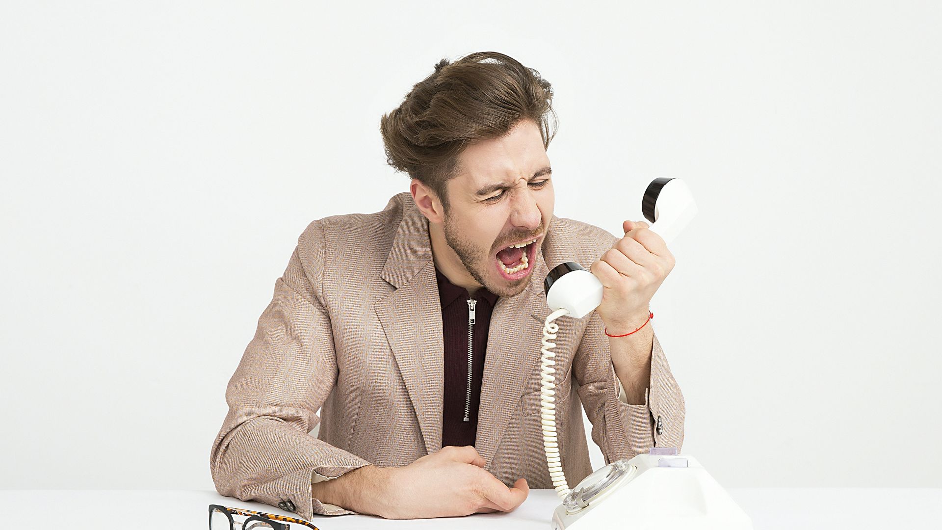man holding telephone screaming