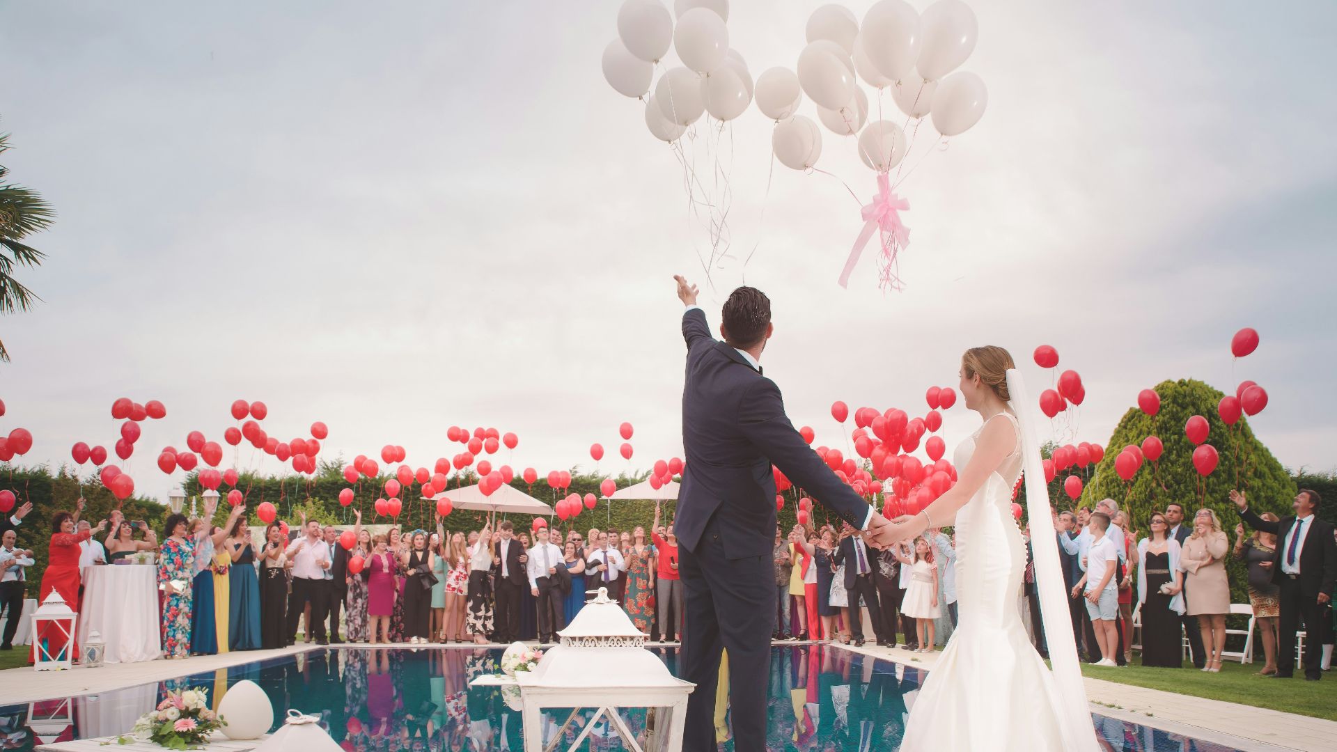 photo of a man and woman newly wedding holding a balloons