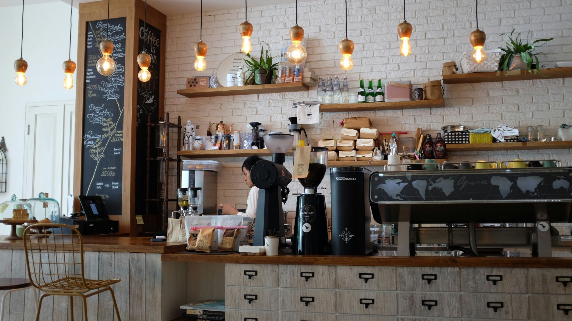 black kitchen appliance on kitchen island with pendant lights