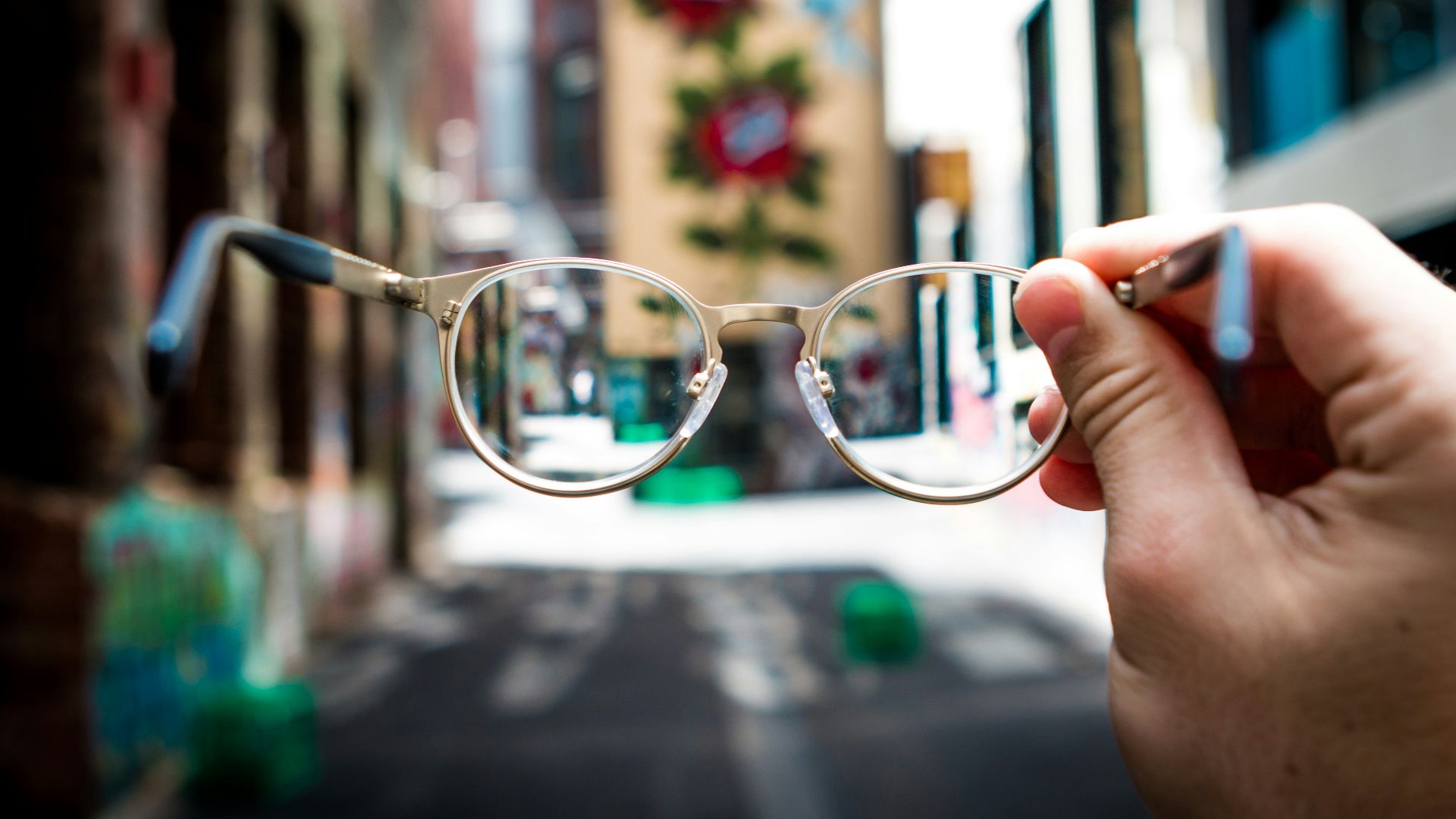 person holding eyeglasses