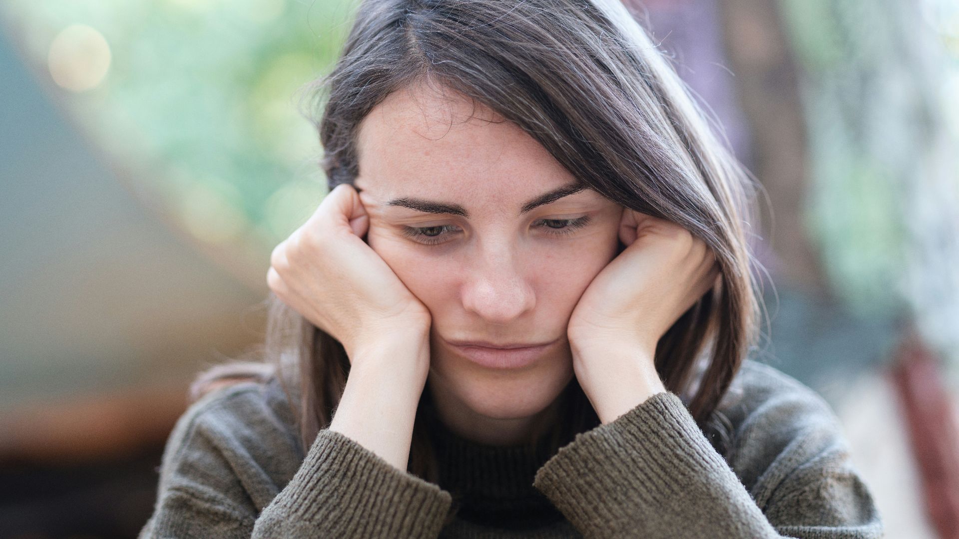 a woman holding her head in her hands