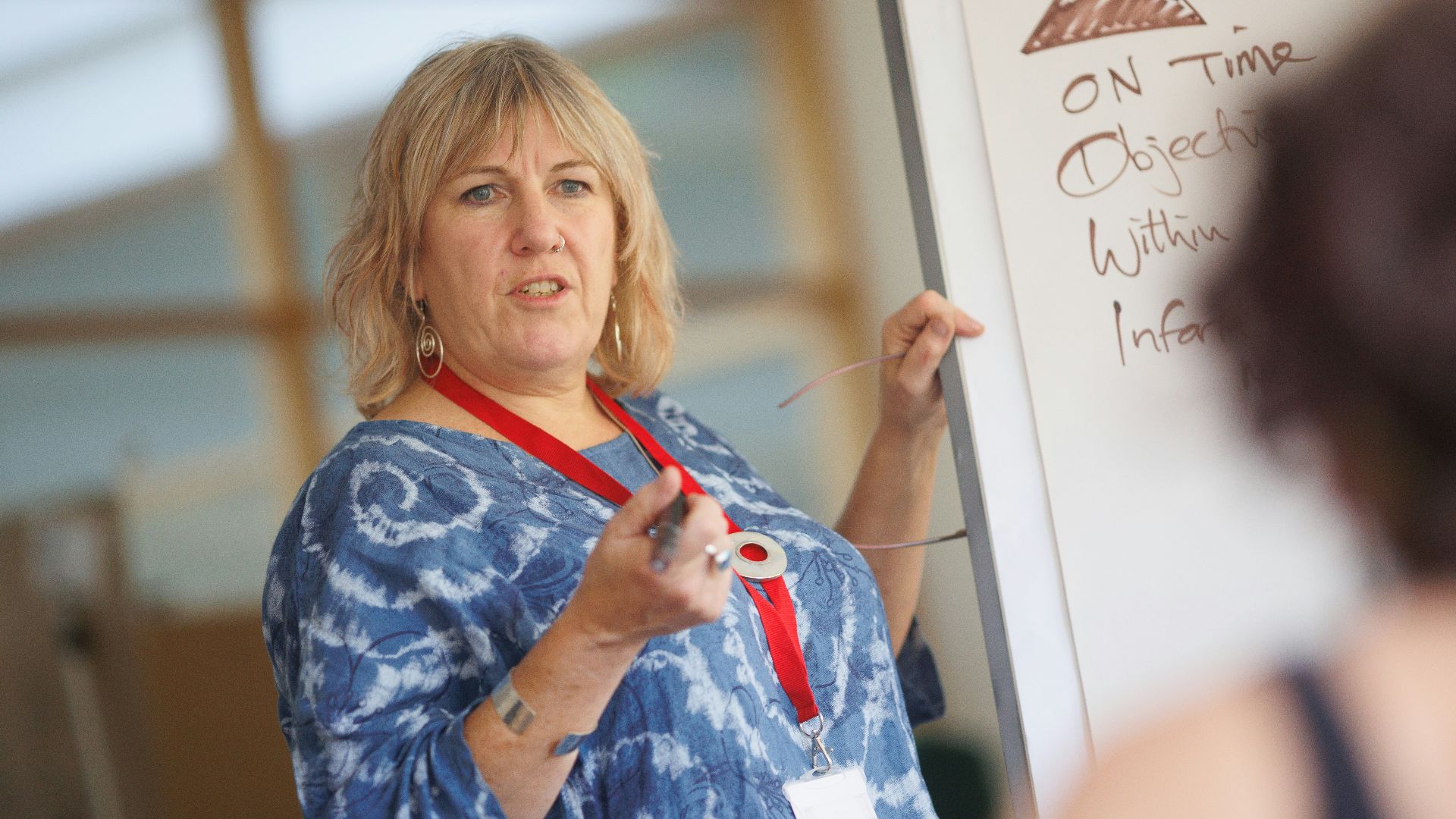a person writing on a whiteboard