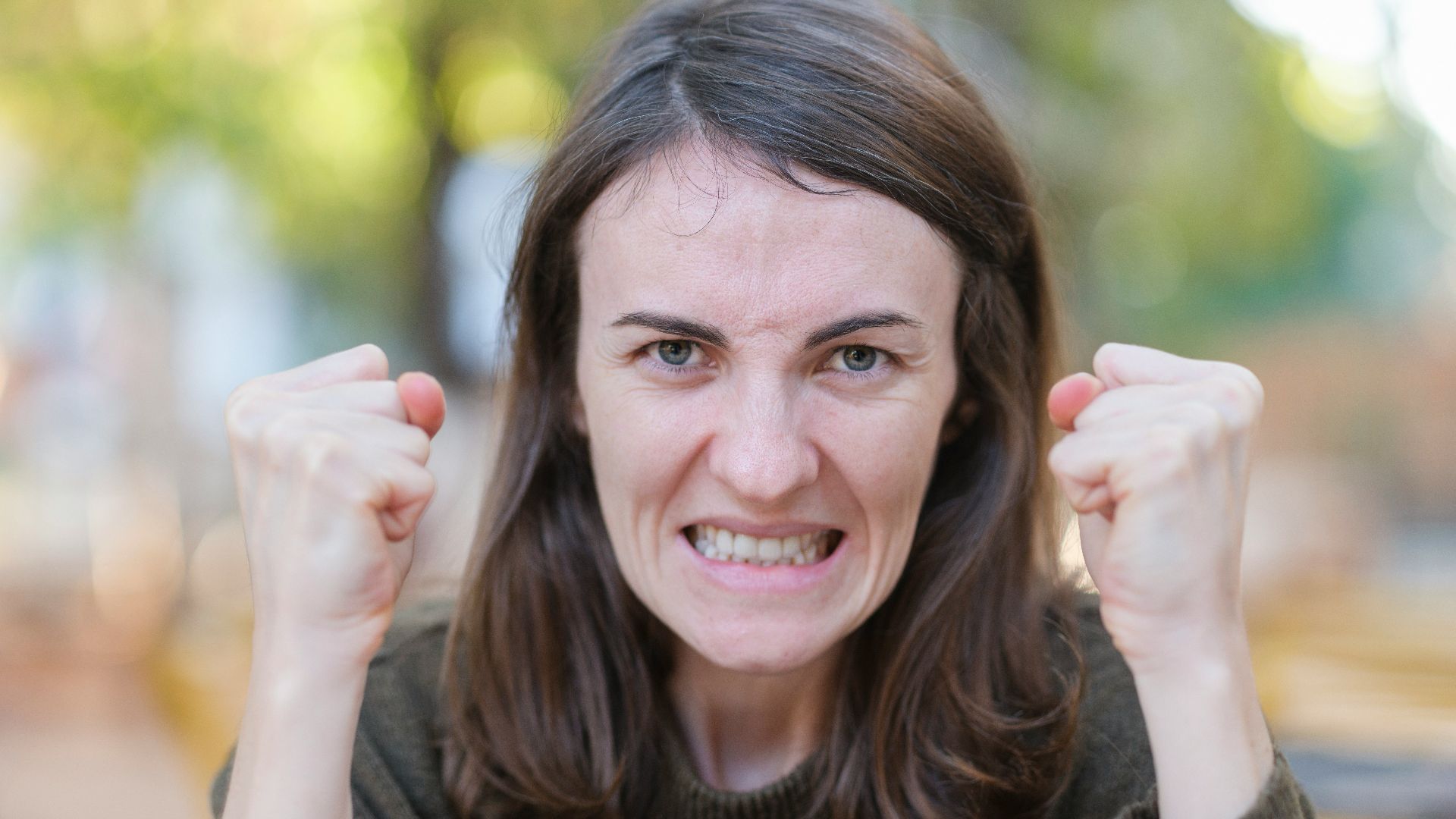 a woman holding her fists up in the air