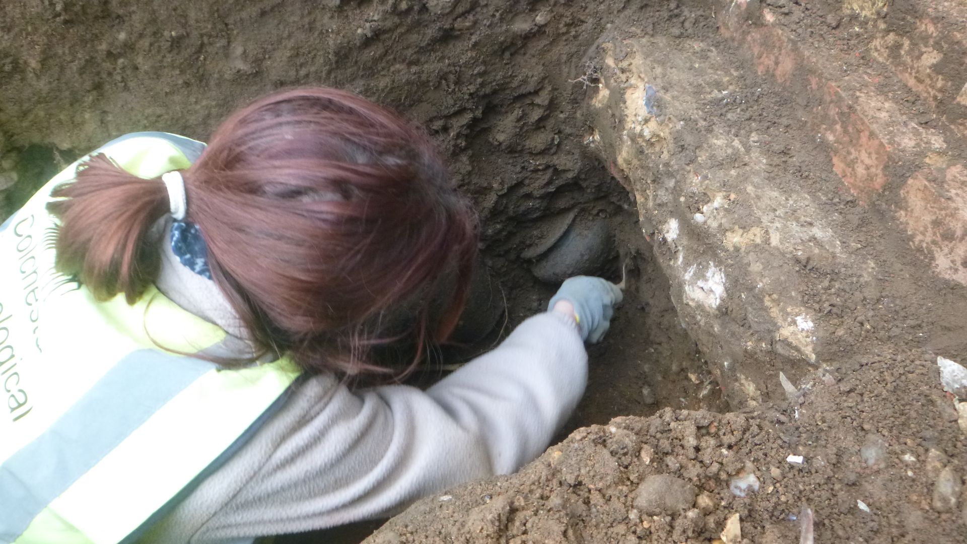 File:Archaeologist excavating a small find at 86 Lexden Road, Colchester, Essex, January 2023.jpg