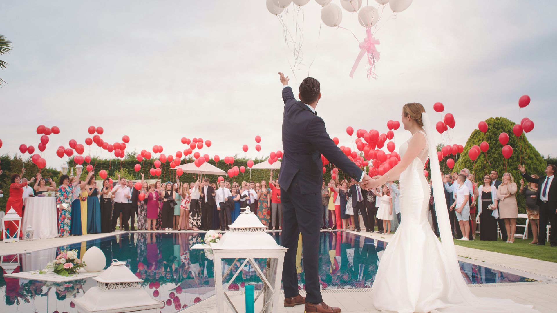 photo of a man and woman newly wedding holding a balloons